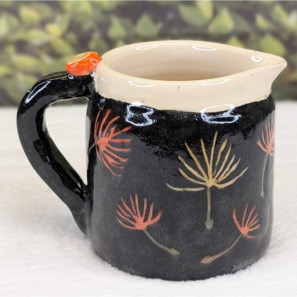 Handcrafted Black Ceramic Pitcher with Floral Design